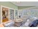 Inviting sunroom with cozy white seating and a view of the outdoors at 2076 Rookery Ln, Charleston, SC 29414