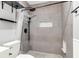 Walk-in shower with gray tile surround, overhead shower head, and built-in niche at 21 Rivers Point Row # Apt 11 C, Charleston, SC 29412