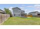 The backyard features a screened porch, a brick patio with a firepit, and a grassy area with wood fencing at 212 Palmetto Walk Dr, Summerville, SC 29486