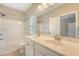 Stylish bathroom with double sinks, a large mirror and a shower-tub combo at 212 Palmetto Walk Dr, Summerville, SC 29486