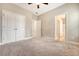Cozy bedroom featuring neutral carpet, a ceiling fan and an attached bathroom at 212 Palmetto Walk Dr, Summerville, SC 29486