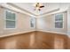 Primary bedroom with tray ceiling, hardwood floors, and large windows at 212 Palmetto Walk Dr, Summerville, SC 29486