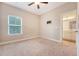 Cozy bedroom featuring neutral carpet, a ceiling fan and a window allowing for ample natural light at 212 Palmetto Walk Dr, Summerville, SC 29486