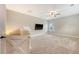 Cozy bonus room featuring neutral carpet, ceiling fan and tv, creating a comfortable living space at 212 Palmetto Walk Dr, Summerville, SC 29486