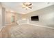 Spacious bonus room with gray carpet, ceiling fan and tv, perfect for entertaining at 212 Palmetto Walk Dr, Summerville, SC 29486
