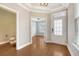 Inviting foyer with gleaming hardwood floors, decorative molding, and glass French doors to another room at 212 Palmetto Walk Dr, Summerville, SC 29486