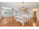Bright living area with hardwood floors, chandelier, and staircase leading to upper level at 212 Palmetto Walk Dr, Summerville, SC 29486