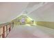 Finished attic with neutral carpet, shelving, and window offers versatile space for storage or additional living area at 2120 Fife Ln, Charleston, SC 29414