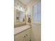 Charming bathroom with bright vanity, decorative lighting, and shuttered window offering natural light and a fresh, clean look at 2120 Fife Ln, Charleston, SC 29414