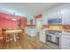 Open kitchen with white cabinets, stainless appliances, and a round dining table, seamlessly blending cooking and dining spaces at 2120 Fife Ln, Charleston, SC 29414