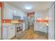 Bright kitchen featuring stainless steel appliances, white cabinetry, and a view into the connected dining area for easy entertaining at 2120 Fife Ln, Charleston, SC 29414