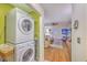 Convenient laundry area with stacked washer and dryer, leading into a cozy living room, making chores feel less isolated at 2120 Fife Ln, Charleston, SC 29414