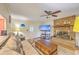 Cozy living room with a brick fireplace, plush sofa, and modern ceiling fan, creating a warm and inviting atmosphere at 2120 Fife Ln, Charleston, SC 29414