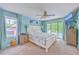 Serene main bedroom with a king bed, ceiling fan, and access to a private balcony overlooking the pool, blending comfort and luxury at 2120 Fife Ln, Charleston, SC 29414