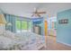 This inviting main bedroom features a private ensuite bathroom, deck access, and a ceiling fan at 2120 Fife Ln, Charleston, SC 29414