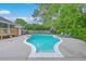 Kidney-shaped pool offers a great way to cool off and enjoy the summer months, complete with sun loungers and wooded backdrop at 2120 Fife Ln, Charleston, SC 29414