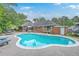 A pristine pool is surrounded by outdoor seating and lush greenery, creating a serene backyard oasis for relaxation and entertaining at 2120 Fife Ln, Charleston, SC 29414