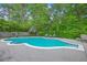 This kidney-shaped pool is surrounded by a concrete patio, greenery and chaise lounges for relaxation and fun in the sun at 2120 Fife Ln, Charleston, SC 29414