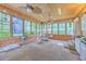 Charming sunroom with exposed brick, a swing and a ceiling fan at 2120 Fife Ln, Charleston, SC 29414