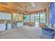 Well lit sunroom with exposed brick, and a sink with cabinets at 2120 Fife Ln, Charleston, SC 29414