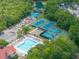 The aerial shot shows tennis courts, a playground, and a pool with red umbrellas at 2132 Summerwood Dr, Mount Pleasant, SC 29466