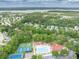 Wide aerial shot of a residential community pool, tennis courts, and surrounding green landscape at 2132 Summerwood Dr, Mount Pleasant, SC 29466