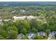 Aerial view of community homes nestled in a lush, green landscape with a distant building at 2132 Summerwood Dr, Mount Pleasant, SC 29466