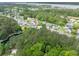 Scenic aerial view of a home nestled among lush trees in a quiet neighborhood, near a pond at 2132 Summerwood Dr, Mount Pleasant, SC 29466