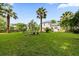 Well-maintained backyard featuring green grass, mature trees, and a view of the home at 2132 Summerwood Dr, Mount Pleasant, SC 29466