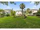 Expansive backyard featuring lush lawn, mature trees, and a charming patio area at 2132 Summerwood Dr, Mount Pleasant, SC 29466