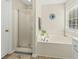 This bright bathroom features a soaking tub and a glass enclosed shower at 2132 Summerwood Dr, Mount Pleasant, SC 29466