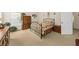 This naturally lit bedroom includes an iron bedframe, neutral carpet, and wood furnishings at 2132 Summerwood Dr, Mount Pleasant, SC 29466