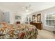 Bright bedroom features an iron bedframe, neutral carpet, and furnishings with a red chair at 2132 Summerwood Dr, Mount Pleasant, SC 29466