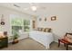 Cozy bedroom features a daybed with decorative pillows, a ceiling fan, and a large window at 2132 Summerwood Dr, Mount Pleasant, SC 29466