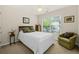 This carpeted bedroom includes a green chair and decorative pillows on the bed at 2132 Summerwood Dr, Mount Pleasant, SC 29466