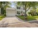 Inviting two-story home featuring a well-kept lawn, large driveway, and attached garage at 2132 Summerwood Dr, Mount Pleasant, SC 29466