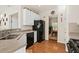Bright kitchen with white cabinets, black appliances, and hardwood floors at 2132 Summerwood Dr, Mount Pleasant, SC 29466