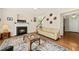 Bright living room features a fireplace, ceiling fan, hardwood floors and a decorative rug at 2132 Summerwood Dr, Mount Pleasant, SC 29466