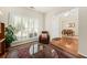 Bright living room with hardwood floors, a chair, and a view to the dining area at 2132 Summerwood Dr, Mount Pleasant, SC 29466