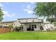 Spacious backyard featuring a covered patio, lush green lawn, and privacy from mature trees at 218 Austin Creek Ct, Summerville, SC 29483