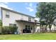 Beautiful backyard featuring a covered patio, lush green lawn, and privacy from mature trees at 218 Austin Creek Ct, Summerville, SC 29483