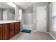 Bathroom featuring a vanity with wood cabinets, a shower and tub combo, and a large mirror at 218 Austin Creek Ct, Summerville, SC 29483