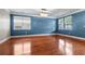 Spacious bedroom features hardwood floors, blue accent wall, chandelier, and bright natural light at 218 Austin Creek Ct, Summerville, SC 29483