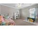 Bright bedroom featuring a bed, vanity table, and natural light from the windows at 218 Austin Creek Ct, Summerville, SC 29483