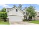 Charming two-story home with a two-car garage, stone accents, lush lawn, and manicured landscaping at 218 Austin Creek Ct, Summerville, SC 29483