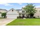 Charming two-story home featuring a two-car garage, well-manicured lawn, and welcoming front porch at 218 Austin Creek Ct, Summerville, SC 29483