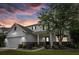 This home with stone accents is bathed in a beautiful sunset at 218 Austin Creek Ct, Summerville, SC 29483