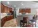 A spacious kitchen featuring wood cabinets, stainless steel appliances, and a breakfast bar with seating at 218 Austin Creek Ct, Summerville, SC 29483