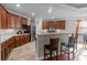 A spacious kitchen featuring wood cabinets, stainless steel appliances, and a breakfast bar with seating at 218 Austin Creek Ct, Summerville, SC 29483