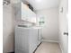 Bright laundry room with white cabinets, modern appliances, and a window at 218 Austin Creek Ct, Summerville, SC 29483
